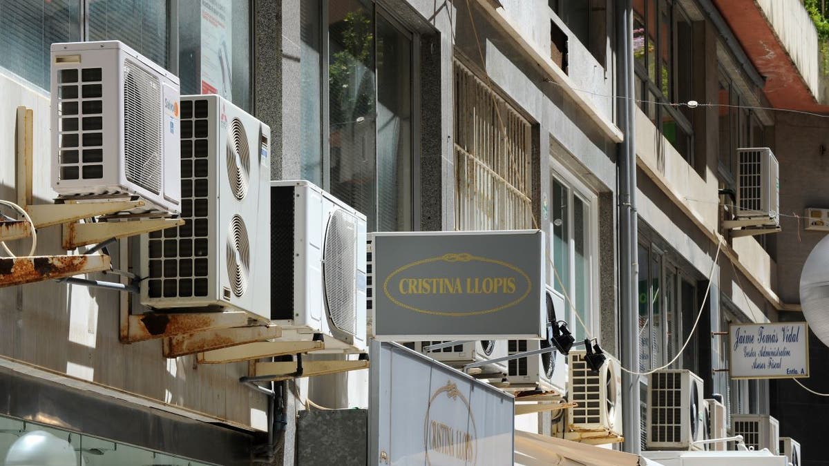 Row of air conditioning units outside businesses in Spain