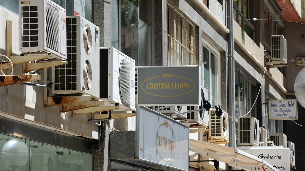 Row of air conditioning units outside businesses in Spain