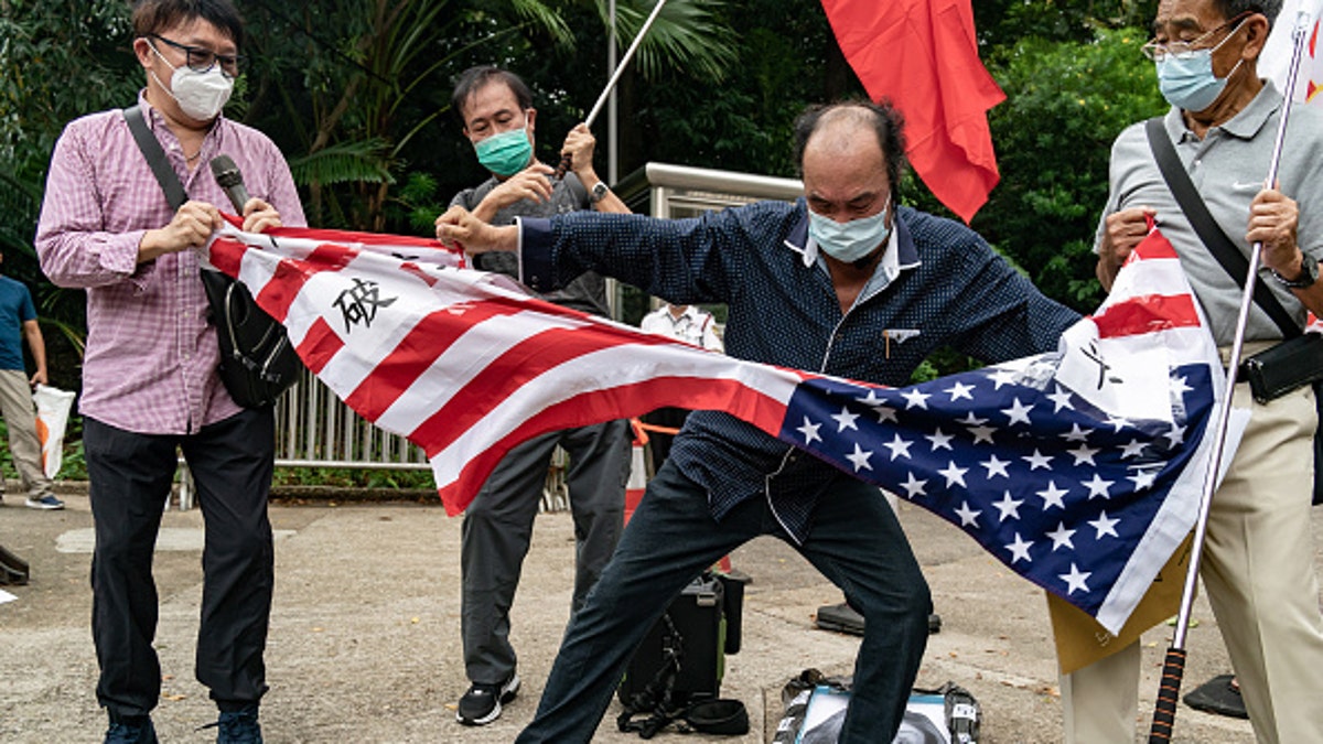 Chinese protestors tear up American flag
