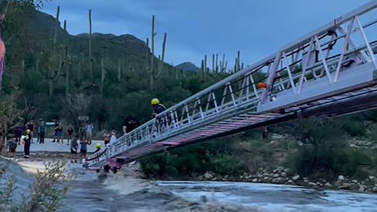 rescuers helping people at low water crossing