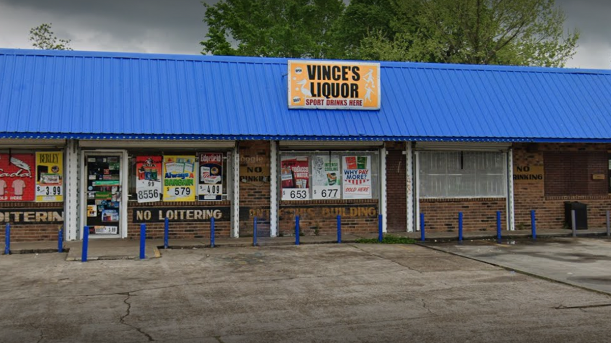 Photo shows exterior entrance for Vince's Liquor store in Baton Rouge with "no loitering" signs in view