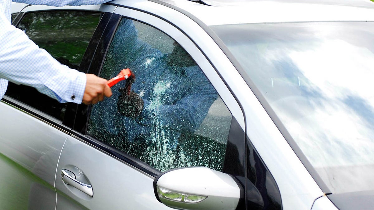 Man smashing window with hammer