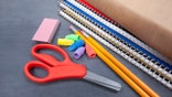Scissors, eraser, notebooks, and pencils