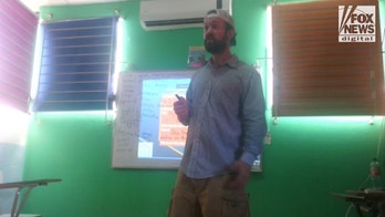 RJ McLeod caught: Most Wanted fugitive captured in El Salvador pictured teaching English class at local school