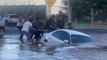 Dramatic video shows Texas woman being rescued before car plunges into sinkhole