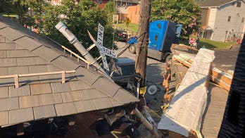 Maryland Amtrak train hits flatbed truck trapped on tracks by traffic