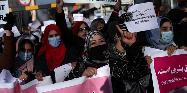 Afghan women shout slogans during a rally to protest against what the protesters say is Taliban restrictions on women, in Kabul, Afghanistan, on Dec. 28, 2021.