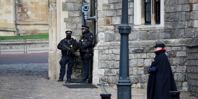 Police officers stand guard in front of Windsor Castle.