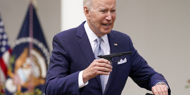 U.S. President Joe Biden holds up a ghost gun kit while announcing new measures by his administration to fight ghost gun crime at the White House in, Washington, U.S., April 11, 2022. 