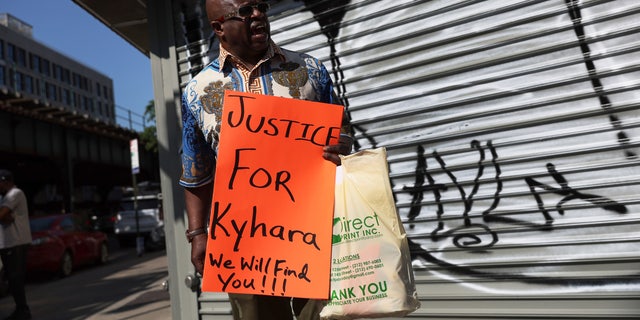 Community activist Calvin Hunt calls for justice with a roadside memorial where, according to the NYPD, an 11-year-old girl was fatally caught in the crossfire of gunfire on May 17, 2022, in the Bronx borough of New York City.