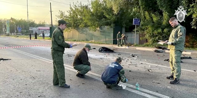 Investigators work at the site of a suspected car bomb attack that killed Darya Dugina, daughter of ultra-nationalist Russian ideologue Alexander Dugin, in the Moscow region, Russia August 21, 2022, in this still image taken from video. 