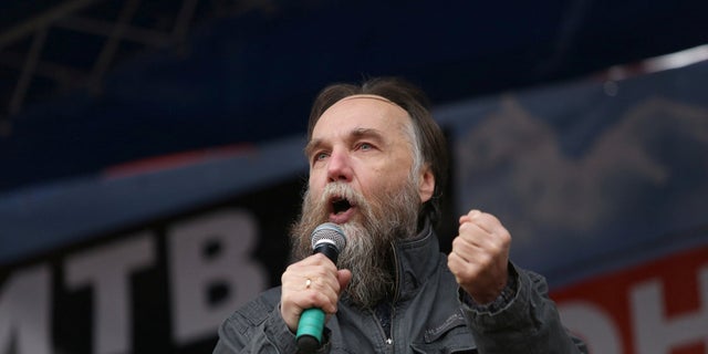 Russian politologist Alexander Dugin gestures as he addresses the rally 