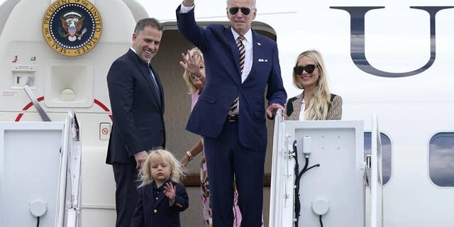 President Joe Biden, center, waves as he is joined by, from left, son Hunter Biden, grandson Beau Biden, first lady Jill Biden, and daughter-in-law Melissa Cohen