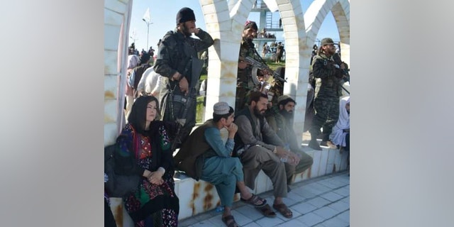Meena Habib sits surrounded by Taliban members