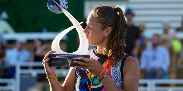 Russia's Daria Kasatkina Mubadala kisses the Silicon Valley Classic trophy after a 6-7 (2), 6-1, 6-2 win over American Shelby Rogers on Sunday in San Jose, Calif., Aug. 7, 2022.