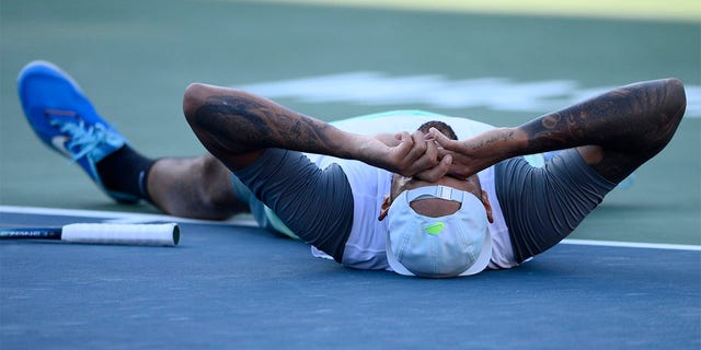 Nick Kyrgios of Australia lies on the court after defeating Yoshihito Nishioka of Japan in the final at the City Open tennis tournament, Sunday, Aug. 7, 2022, in Washington.  Kyrgios won 6-4, 6-3.