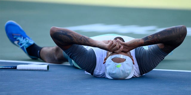 Nick Kyrgios of Australia lies on the court after defeating Yoshihito Nishioka of Japan in the final at the City Open tennis tournament, Sunday, Aug. 7, 2022, in Washington. Kyrgios won 6-4, 6-3.
