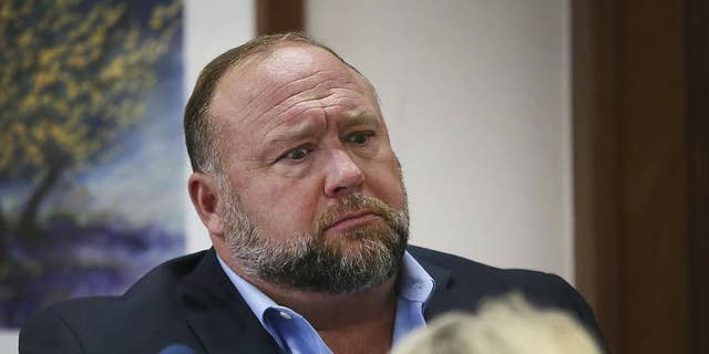 Conspiracy theorist Alex Jones attempts to answer questions about his emails asked by Mark Bankston, lawyer for Neil Heslin and Scarlett Lewis, during trial at the Travis County Courthouse in Austin.