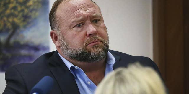 Conspiracy theorist Alex Jones attempts to answer questions about his emails asked by Mark Bankston, lawyer for Neil Heslin and Scarlett Lewis, during trial at the Travis County Courthouse in Austin.