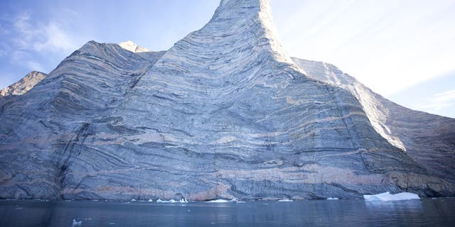 Composed of three-million year old gneiss, Ingmikortilaq presented the climbers with numerous challengesloose rock, holds breaking off in their hands, and slick marble-like surfaces that required extra grip strength to hang on.