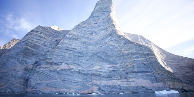 Composed of three-million year old gneiss, Ingmikortilaq presented the climbers with numerous challenges—loose rock, holds breaking off in their hands, and slick marble-like surfaces that required extra grip strength to hang on.