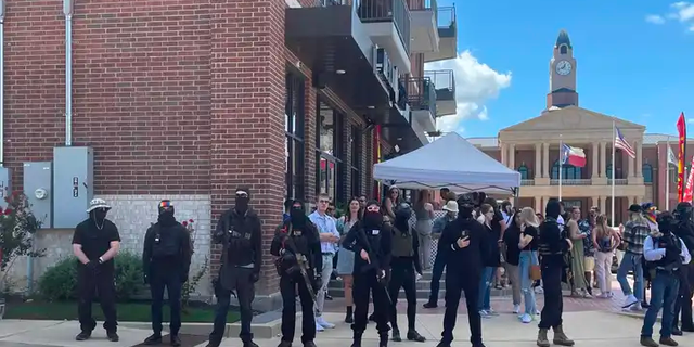 Armed protesters stand guard outside a drag show at Anderson Distillery and Grill in Roanoke, Texas.