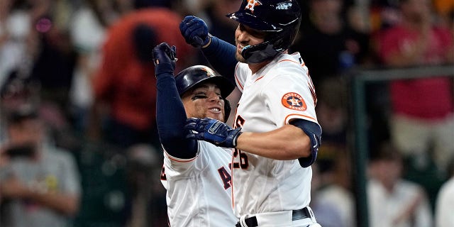 Houston Astros' Trey Mancini, right, celebrates with Christian Vazquez after hitting a two-run home run against the Boston Red Sox during the second inning of a baseball game Wednesday, Aug. 3, 2022, in Houston.