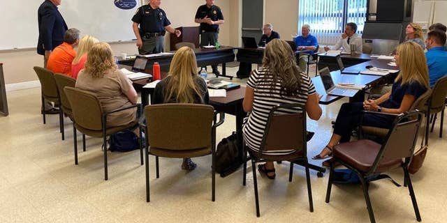 Sheriff Buddy Harwood and Lt. Coy Phillips meet with school system administration July 13 to brief them on the enhanced security procedures coming to Madison County Schools.