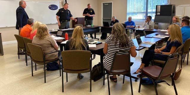 Sheriff Buddy Harwood and Lt. Coy Phillips meet with school system administration July 13 to brief them on the enhanced security procedures coming to Madison County Schools.