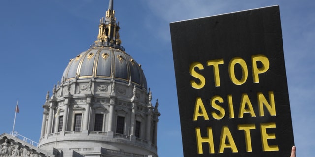 A demonstrator holds a sign saying "Stop Asian Hate" during a march toward City Hall after a rally in front of the Hall of Justice March 22, 2021, in San Francisco. 