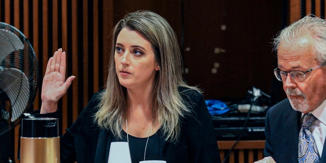 Kate McClure, 32, charged with theft by deception in a $400,00 GoFundMe scam, with her attorney Jim Gero Jr. in State Superior Court, Burlington County Courthouse, Mount Holly, NJ, April 15, 2019. 