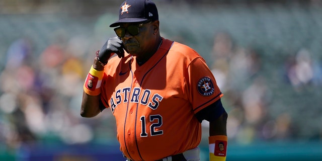 Houston Astros manager Dusty Baker Jr. walks toward the dugout after making a pitching change during the seventh inning of his team's baseball game against the Oakland Athletics in Oakland, Calif., on July 27, 2022.