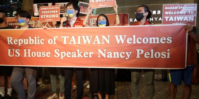 Supporters hold a banner outside the hotel where U.S. House Speaker Nancy Pelosi is supposed to be staying in Taipei, Taiwan, Tuesday, Aug 2, 2022.