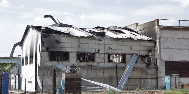 FILE - In this photo taken from video a view of a destroyed barrack at a prison in Olenivka, in an area controlled by Russian-backed separatist forces, eastern Ukraine, on July 29, 2022. Russia and Ukraine accused each other Friday of shelling a prison in a separatist region of eastern Ukraine, an attack that reportedly killed dozens of Ukrainian military prisoners who were captured after the fall of a southern port city of Mariupol in May.