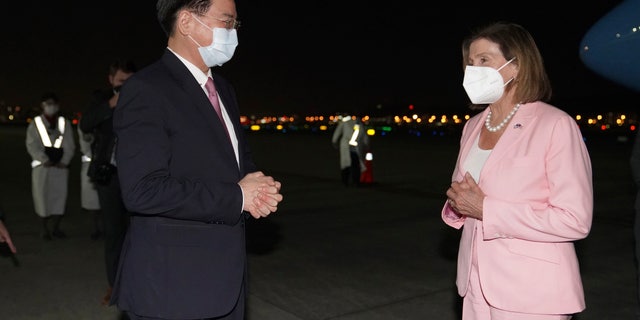 U.S. House Speaker Nancy Pelosi, right, is greeted by Taiwan's Foreign Minister Joseph Wu as she arrives in Taipei, Taiwan, Tuday, Aug. 2, 2022.