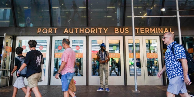 Pedestrians pass an entrance to the Port Authority Bus Terminal in New York. New York's iconic but decrepit bus terminal could be transformed into a state-of-the-art facility by 2031. Officials on Thursday detailed plans for the $10 billion overhaul of the 72-year-old terminal.