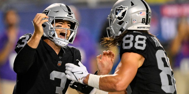 Las Vegas Raiders quarterback Jarrett Stidham, 3, scored a touchdown in the first half of the team's NFL Football Exhibition Hall of Fame game against the Jacksonville Jaguars on Thursday, Aug. 4, 2022. After the fight, he is celebrating with tight end Jacob Hollister, 88.  , Canton, Ohio. 