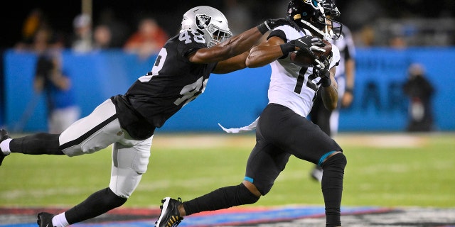 Jacksonville Jaguars wide receiver Marvin Hall (14) runs after a catch with Las Vegas Raiders cornerback Sam Webb (48) defending during the first half of the NFL Hall of Fame Game football exhibition, on Thursday, Aug. 28, 2019. 4, 2022, in Canton, Ohio.