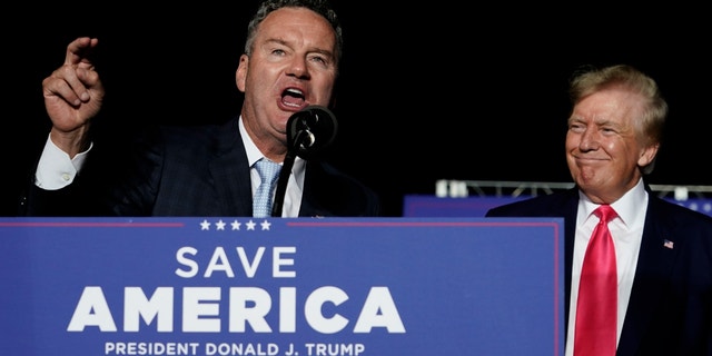 Wisconsin Republican gubernatorial candidate Tim Michels, left speaks as former President Trump, right, listens at a rally Aug. 5, 2022, in Waukesha, Wisconsin.