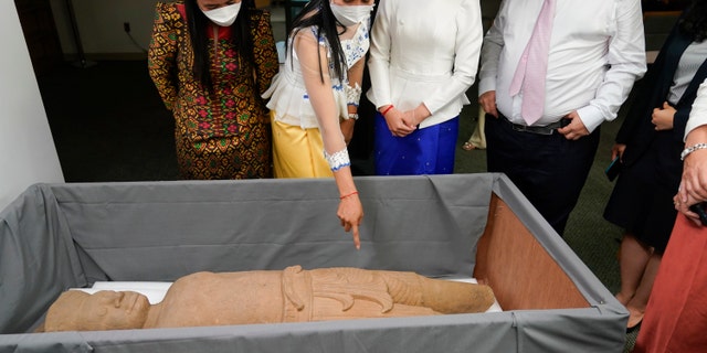 People look at Cambodian antiquities recovered by the US Attorney's office after a news conference in New York. Officials announced the repatriation of 30 antiquities to Cambodia that had been illegally trafficked.