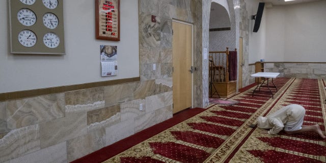 A Muslim man praying on Sunday at the Islamic Center of New Mexico after the fourth Muslim man was murdered in Albuquerque.