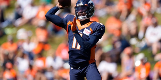 Denver Broncos quarterback Josh Johnson participates in drills during NFL football training camp at team headquarters on August 8, 2022 in Centennial, Colorado.