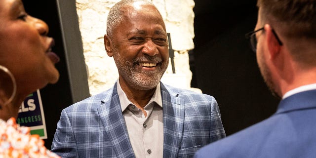 Minnesota's 5th Congressional District candidate Don Samuels, center, is greeted by supporters at his primary election night party, Tuesday, Aug. 9, 2022, at the Canopy by Hilton Minneapolis Mill District in Minneapolis.