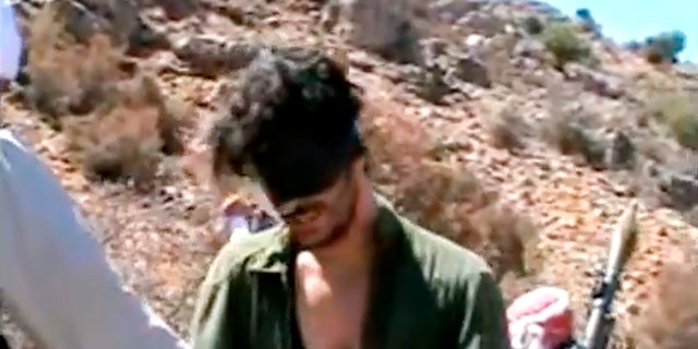 FILE - In this image from an undated video posted on YouTube, American freelance journalist Austin Tice, who had worked for American news outlets in Syria until his disappearance in August 2012, prays in Arabic and English while blindfolded in attendance of armed men. 