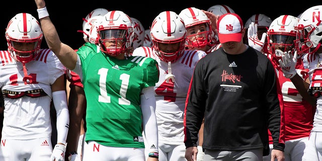 Nebraska red team quarterback Casey Thompson signals the crowd before leading both the red and white teams onto the field alongside head coach Scott Frost before Nebraska's annual spring game at Memorial Stadium in Lincoln on April 9, 2022.