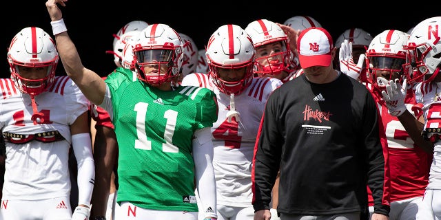 Nebraska red team quarterback Casey Thompson signals the crowd before leading both the red and white teams onto the field alongside head coach Scott Frost before Nebraska's annual spring game at Memorial Stadium in Lincoln on April 9, 2022.