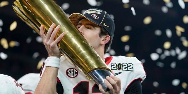 Georgia's Stetson Bennett celebrates after the College Football Playoff championship football game against Alabama, Tuesday, Jan. 11, 2022, in Indianapolis. Georgia's football season is set to begin on Sept. 3, 2022, against Oregon.