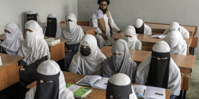 Afghan girls attend a religious school, which remained open since the Taliban took over last year, in Kabul, Afghanistan, Thursday, Aug. 11, 2022.