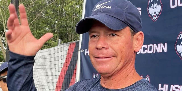 Connecticut head football coach Jim Mora speaks to reporters during the opening day of NCAA college football training camp on July 29, 2022, in Storrs, Conn. Mora is trying to rebuild the football program as an independent in an era of conference mega-mergers.