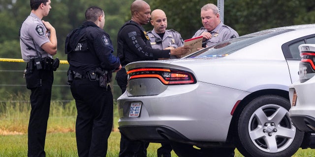 Wake County Sheriff's deputies work at the scene where a deputy was shot and killed in eastern Wake County, NC, near the intersection of Auburn Knightdale and Battle Bridge Road, Friday, Aug. 12, 2022.